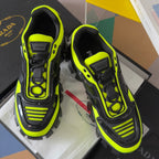Neon green Prada sneakers with black panels, lace-up front, and studded rubber sole