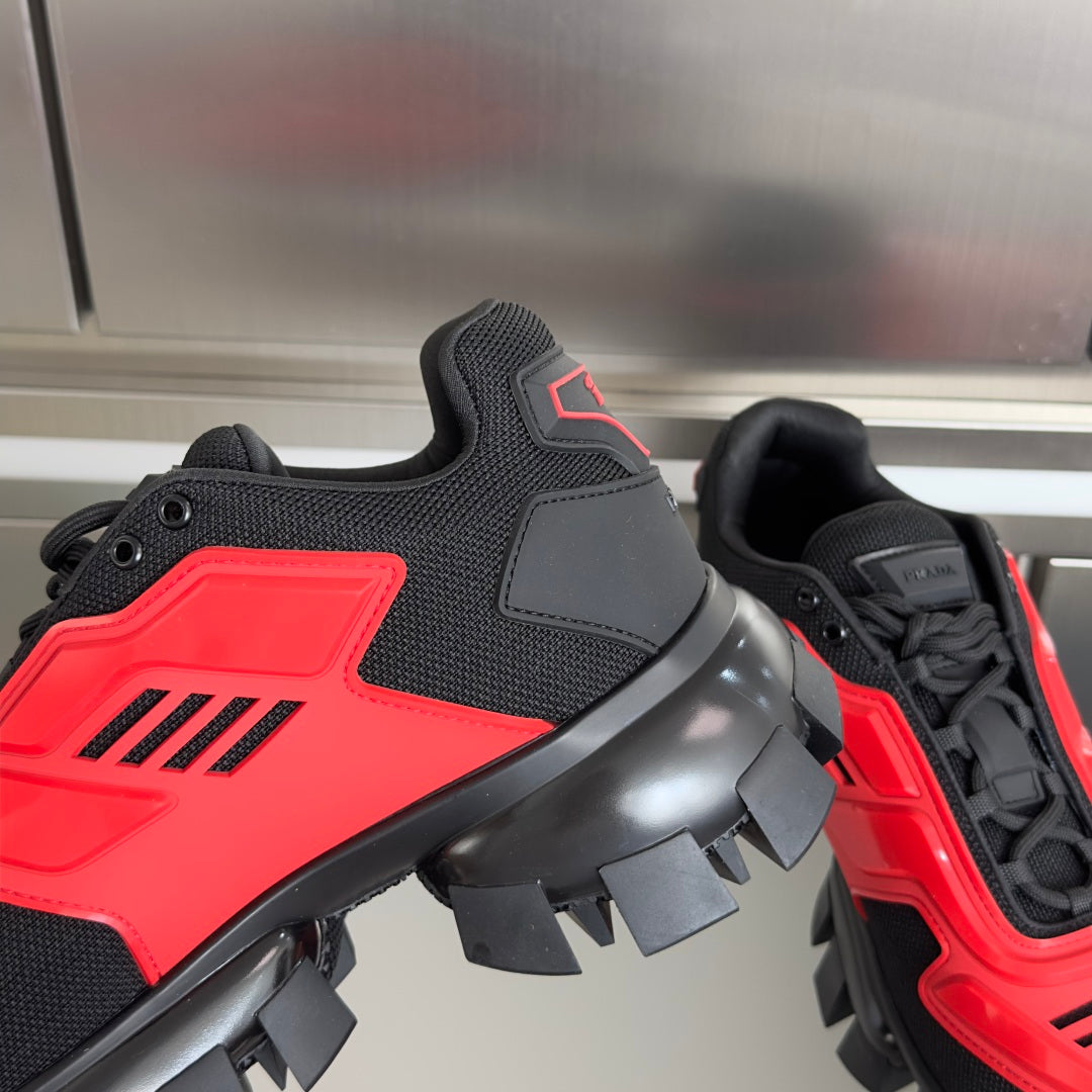Prada unisex sneakers, close-up side with red panel and black laces