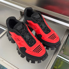 Prada unisex chunky sneakers, red-and-black uppers with lace-up front and spikes.