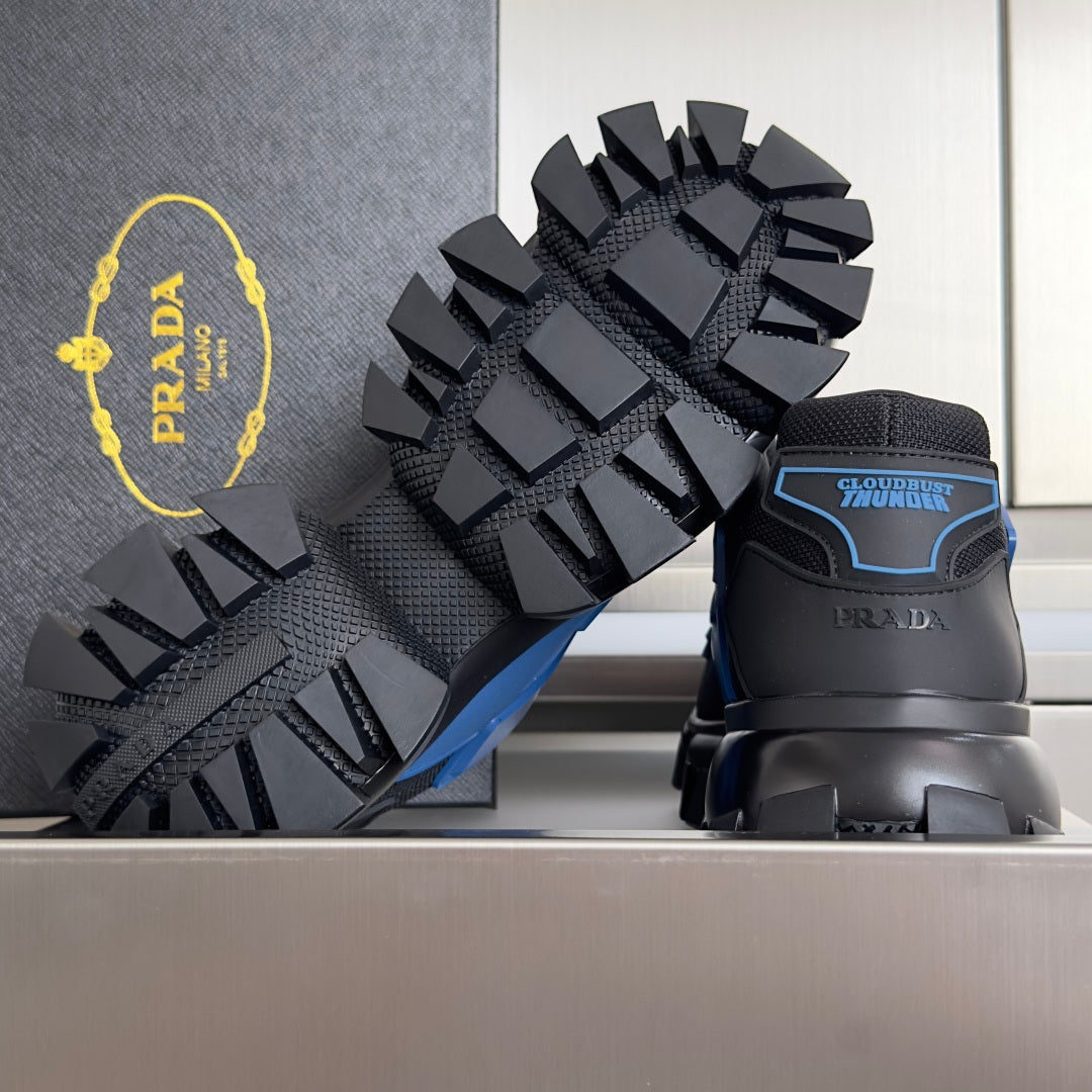 Prada sneakers with blue heel label, chunky tread outsole, and dark platform sole