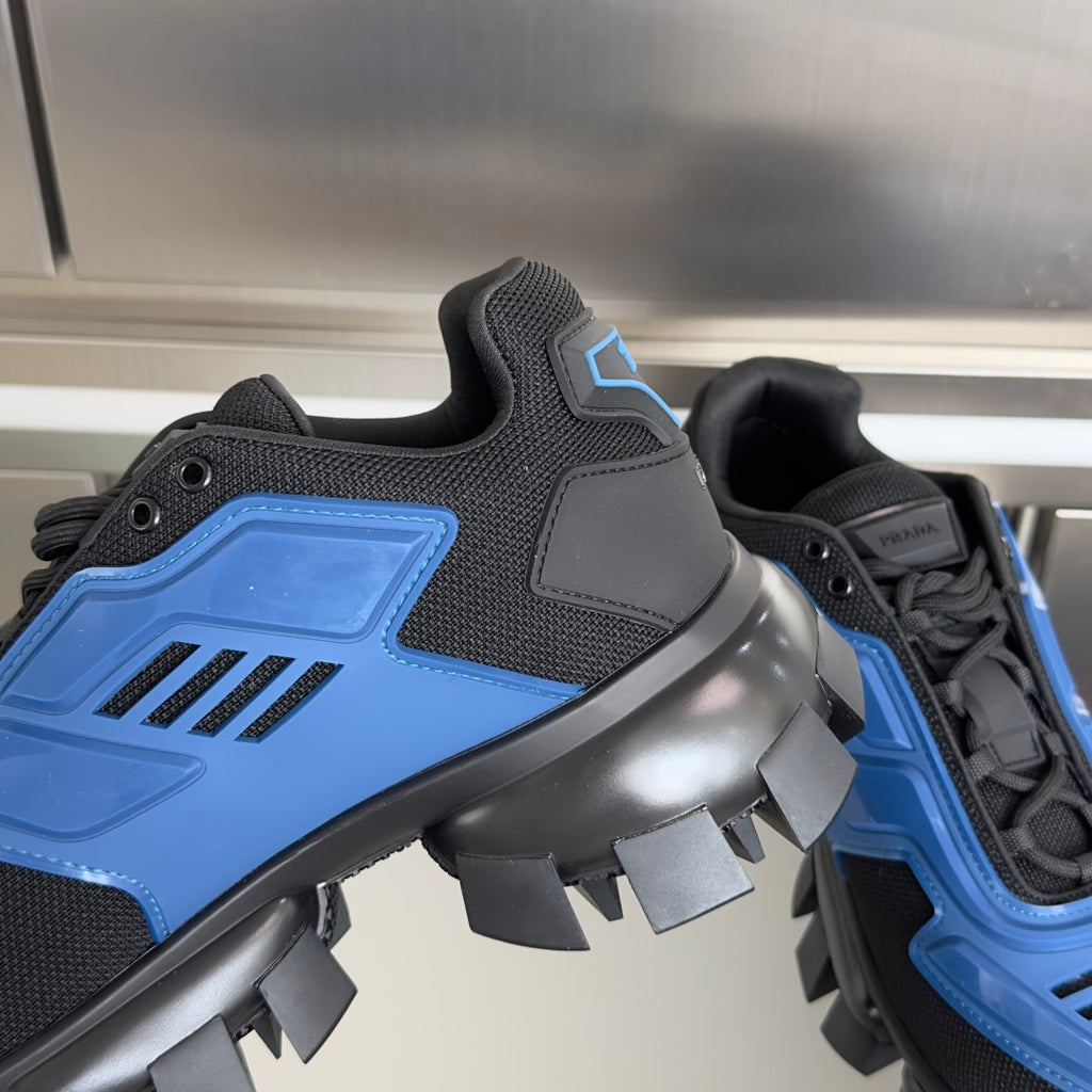 Side view of blue and black sneakers with textured uppers and spiked platform sole