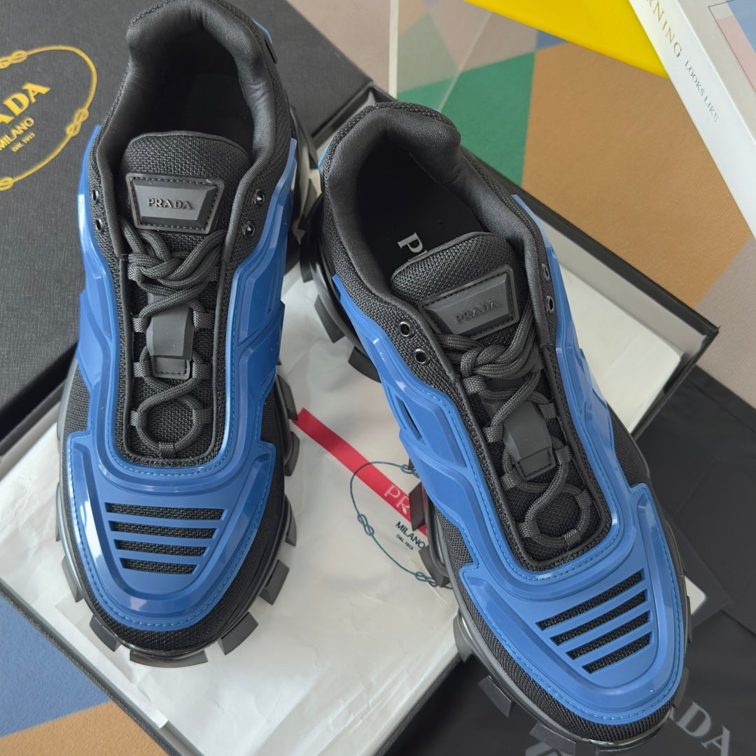 Navy and blue sneakers with lace-up closure, padded collar, and chunky lug sole