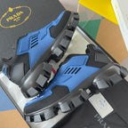 Blue and dark gray sneakers with thick lug outsole and wide strap-like side overlays