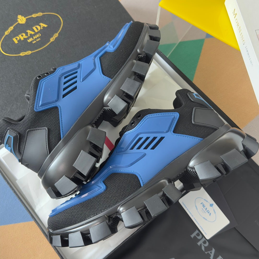 Blue and dark gray sneakers with thick lug outsole and wide strap-like side overlays
