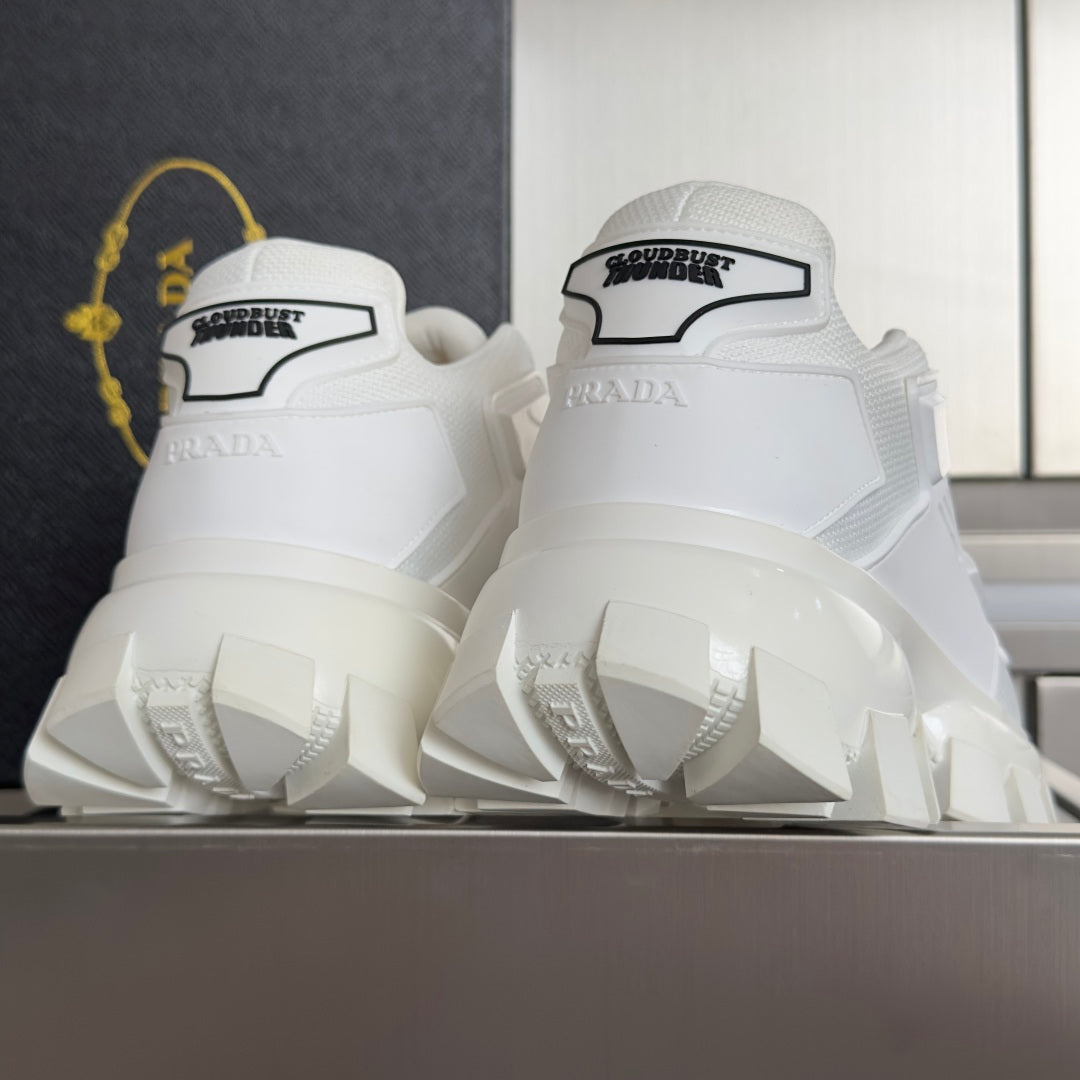 White sneaker heel view with molded back panel and tall block tread