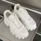 Pair of white lace-up sneakers with chunky lug soles