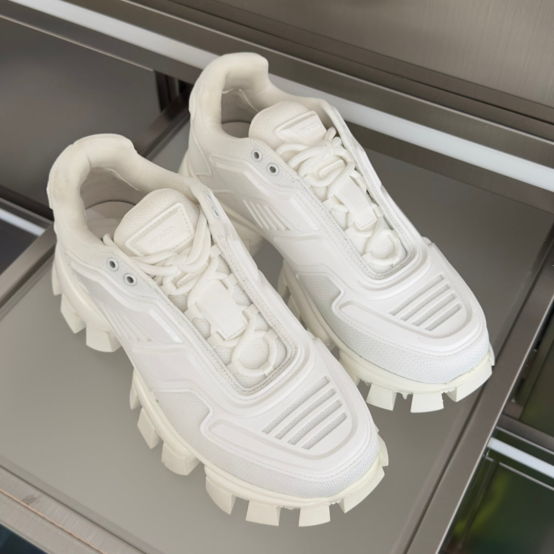 Pair of white lace-up sneakers with chunky lug soles