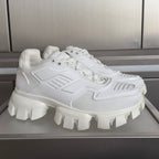 White chunky sneaker with raised lug sole and lace-up front
