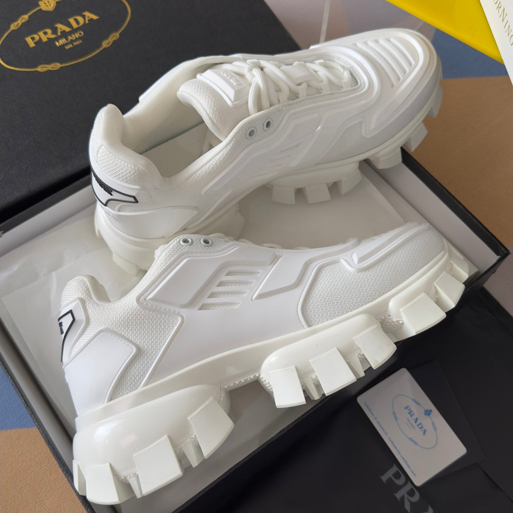 White lace-up sneakers in box, featuring high-traction block tread