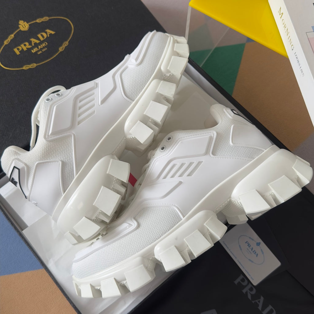 White chunky sneakers with chunky tread blocks and textured upper