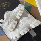 White chunky sneakers with chunky tread blocks and textured upper