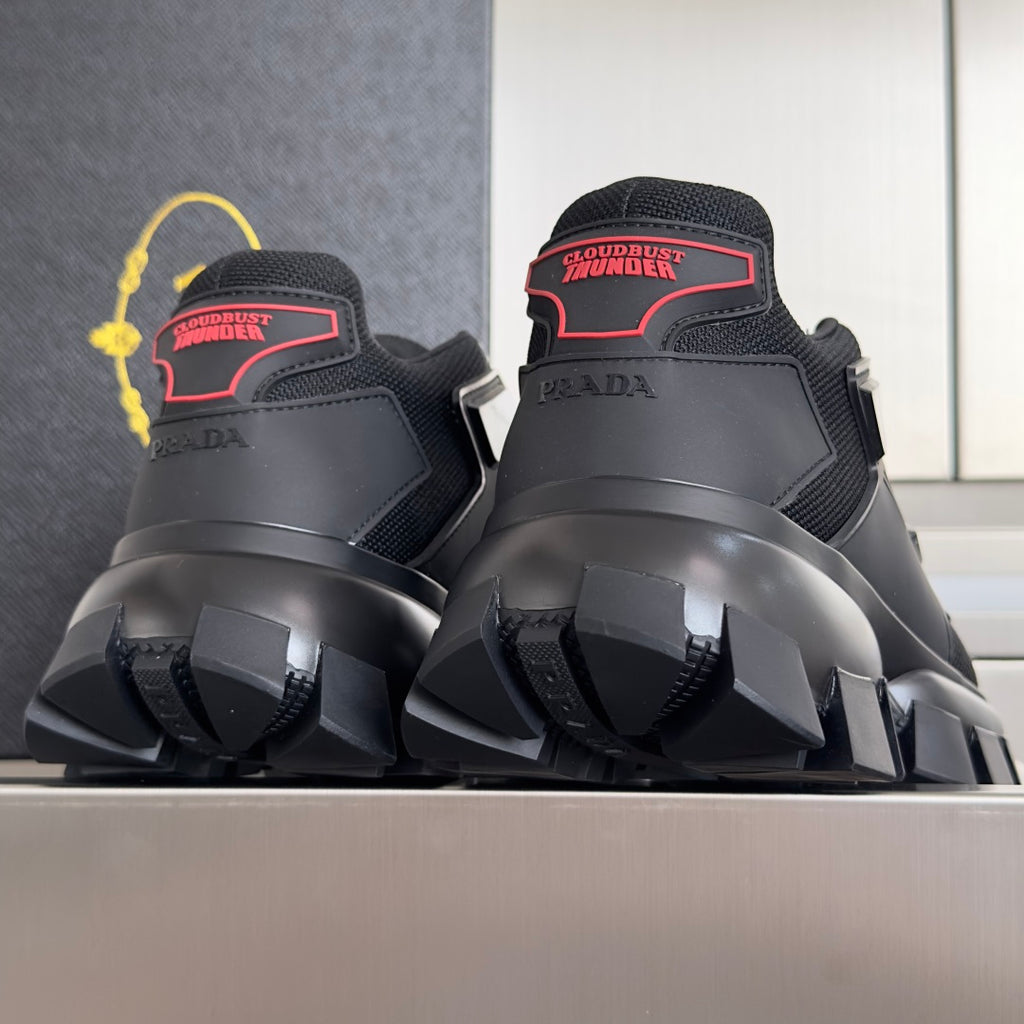 Prada unisex sneakers rear view with “Cloudburst Thunder” ankle label and lug sole