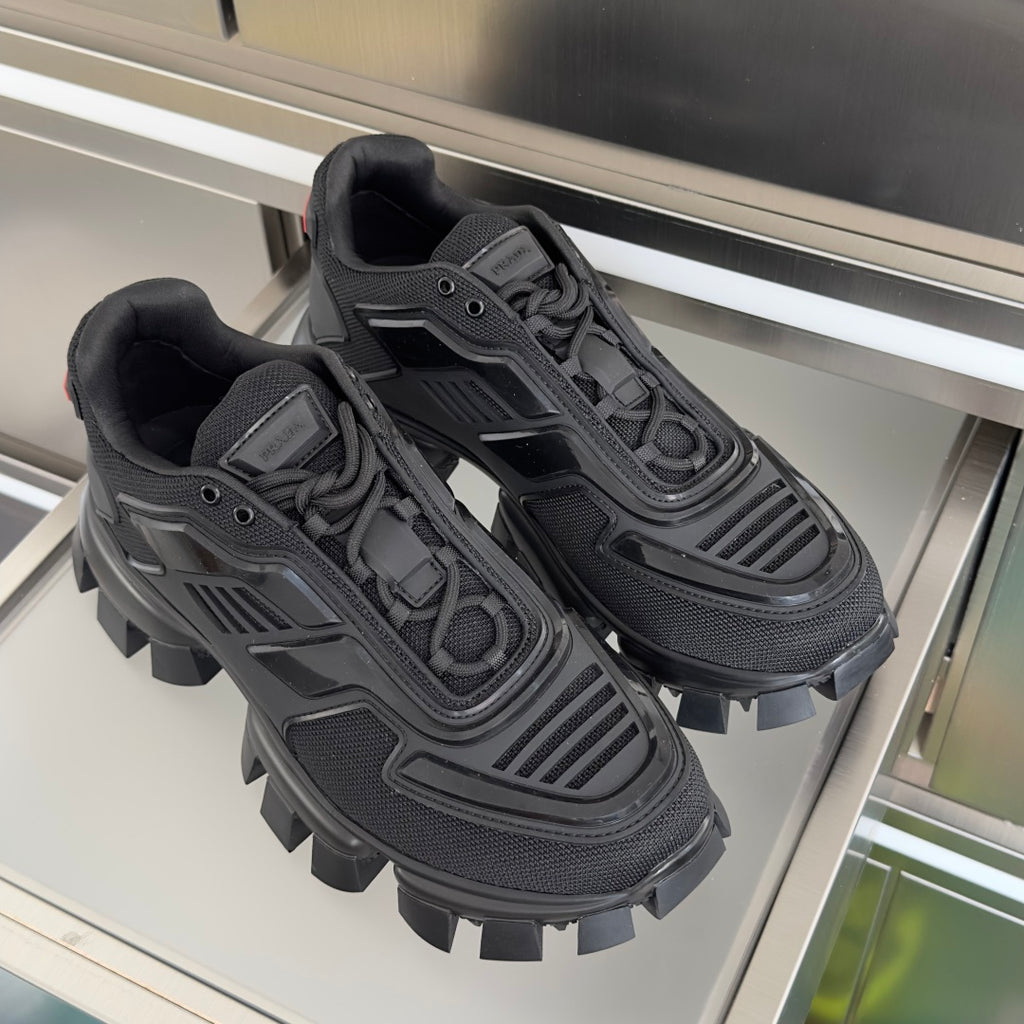 Prada unisex sneakers pair, dark mesh uppers and bold lug soles with lace ties