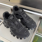 Prada unisex sneakers pair, dark mesh uppers and bold lug soles with lace ties
