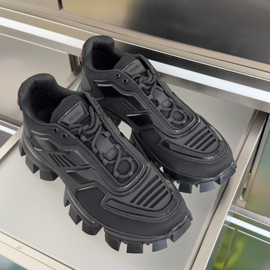 Prada unisex sneakers pair, dark mesh uppers and bold lug soles with lace ties