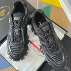Black Prada unisex lace-up sneakers with textured mesh panels and rugged lug soles