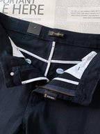Dark denim jeans with white contrast lining and Versace waistband tag