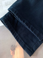 Dark denim jeans folded cuff showing fabric texture and stitching
