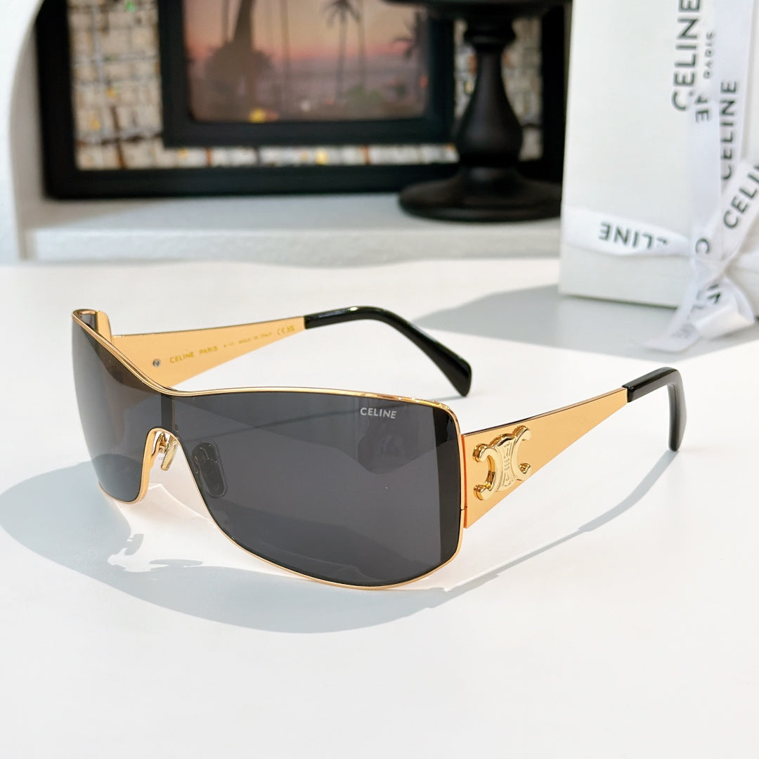 Celine sunglasses with gold frame and dark charcoal tinted lenses, curved shield shape