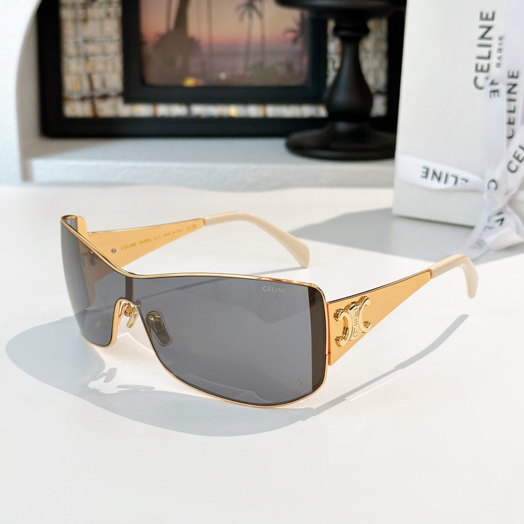 Celine sunglasses with gold frame and dark gray tinted lenses, cat-eye shield shape