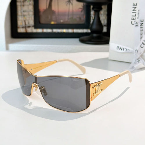 Celine sunglasses with gold frame and dark gray tinted lenses, cat-eye shield shape