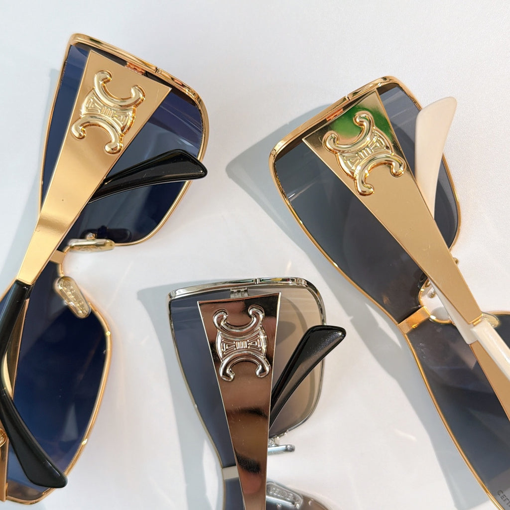Celine sunglasses close-up: gold frame with ornate emblem and dark tinted lenses