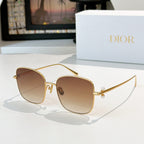 Dior sunglasses with gold frame and tan gradient lenses, square cat-eye style