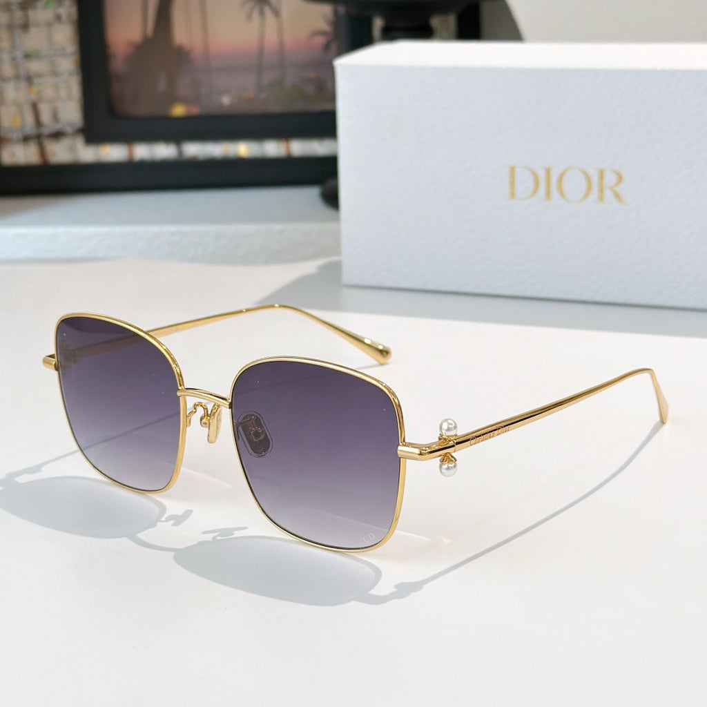 Dior sunglasses with gold frame and dark purple gradient lenses, square cat-eye style