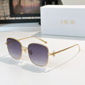 Dior sunglasses with gold frame and dark purple gradient lenses, square cat-eye style