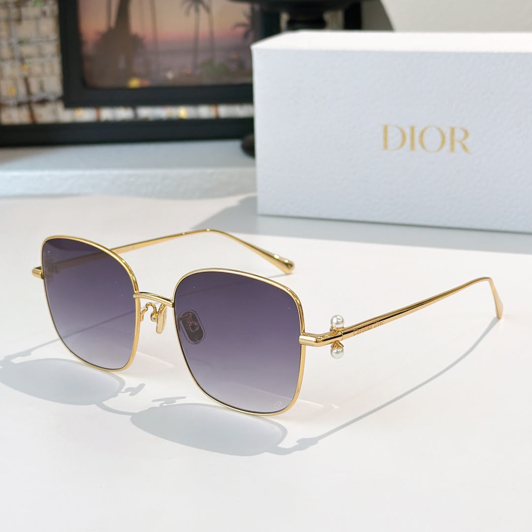 Dior sunglasses with gold frame and dark purple gradient lenses, square cat-eye style