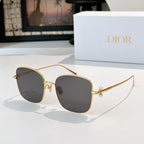 Dior sunglasses with gold frame and dark gray gradient lenses, rounded square cat-eye style