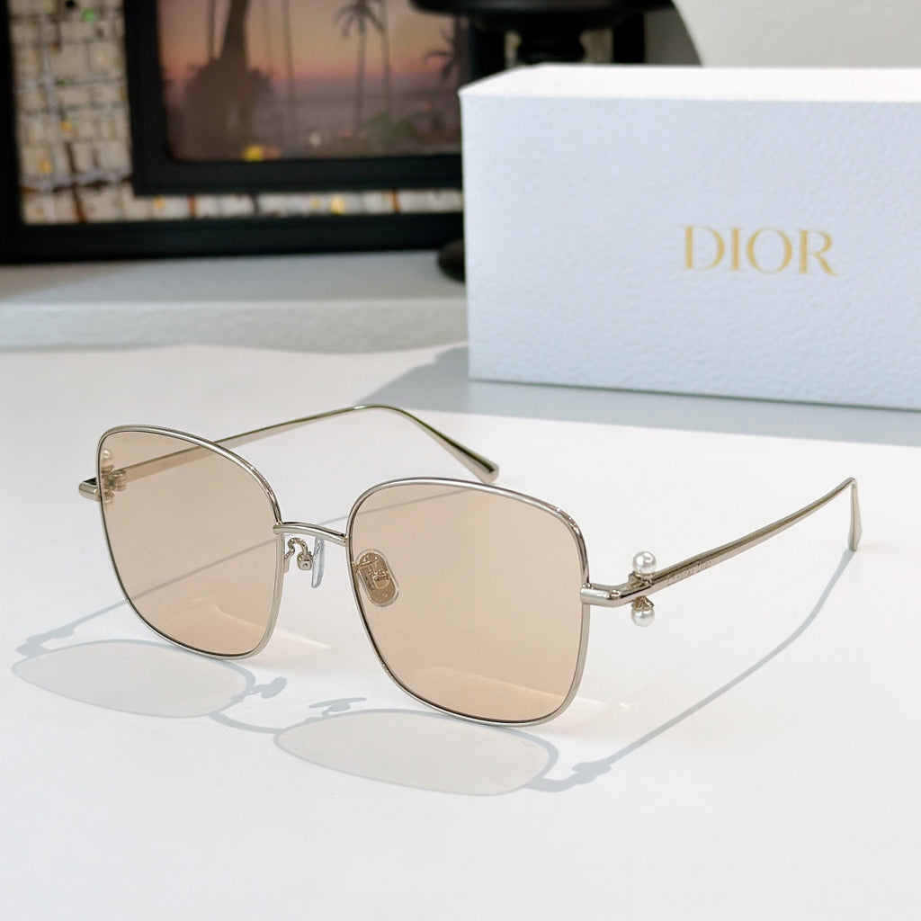 Dior sunglasses with gold frame and light beige gradient lenses, square cat-eye style