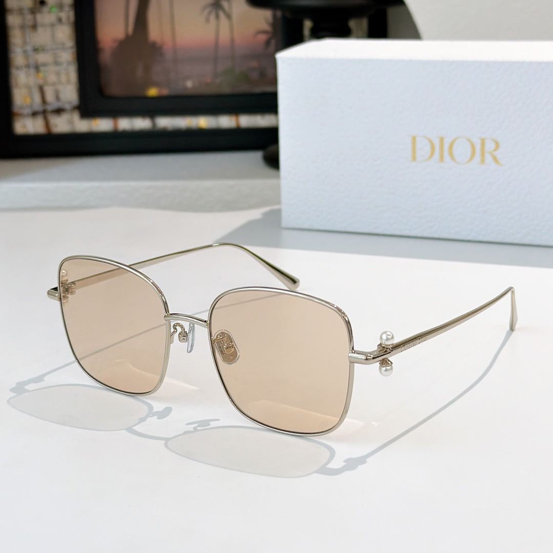 Dior sunglasses with gold frame and light beige gradient lenses, square cat-eye style