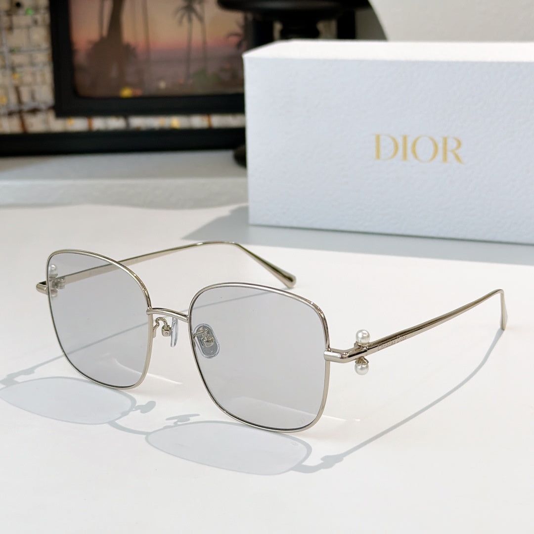Dior sunglasses with silver frame and light gray gradient lenses, square cat-eye style