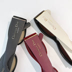 Dior sunglasses shown with black and burgundy cases and partial frames