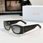Dior cat-eye sunglasses with black frames and pale blue lenses