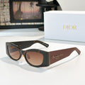 Dior cat-eye sunglasses with black frames and brown gradient lenses