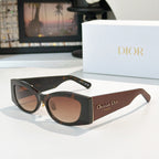 Dior cat-eye sunglasses with black frames and brown gradient lenses