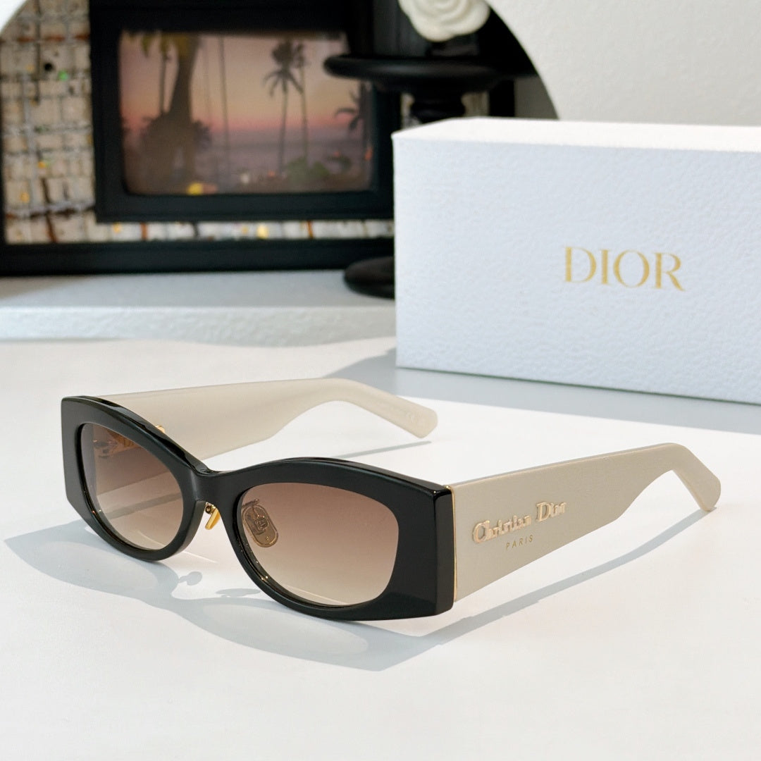 Dior cat-eye sunglasses with black frames, cream temples, and brown lenses