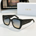 Dior sunglasses with black frames and cool gray gradient lenses