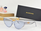 Light blue cat-eye sunglasses with clear arms and gold B emblem