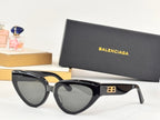 Black cat-eye sunglasses with gray-tinted lenses and gold B logo detail