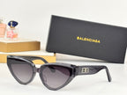 Black cat-eye sunglasses with dark lenses and gold B temple emblem