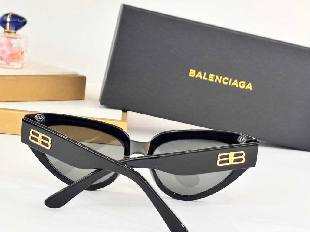 Black cat-eye sunglasses with gray lenses and gold B logo on temples