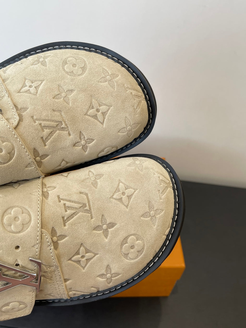 Louis Vuitton beige monogram sandals, close-up of stitched toe and black edge trim