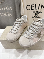 Golden Goose light gray lace-up sneakers with metallic star side detail, pair