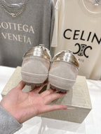 Golden Goose light gray sneakers heel view with branded back details, pair