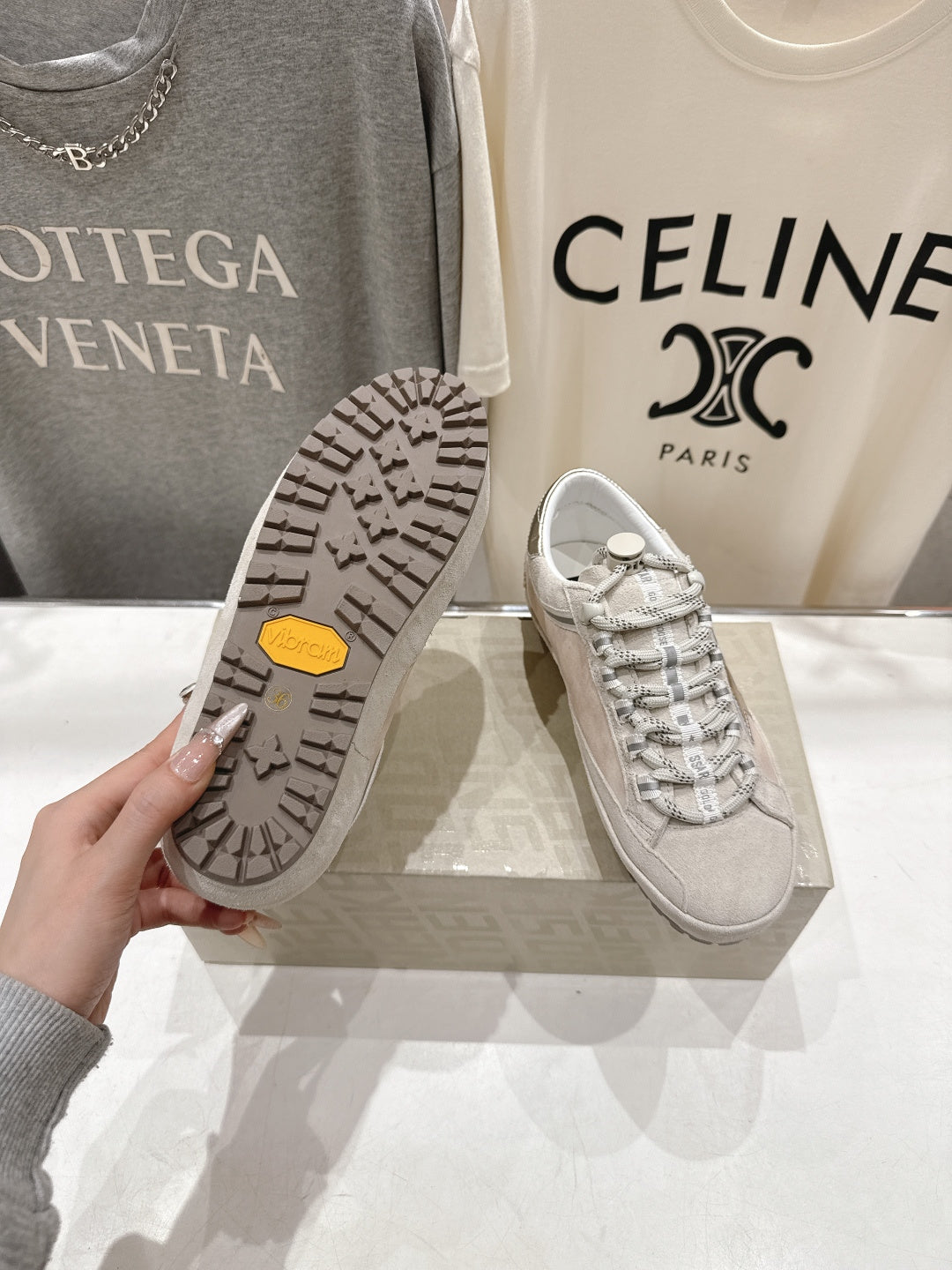 Golden Goose light gray sneaker outsole with textured tread and signature yellow logo