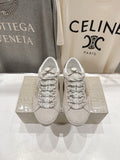 Golden Goose light gray lace-up sneakers with patterned laces and logo detail, pair