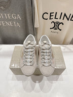 Golden Goose light gray lace-up sneakers with patterned laces and logo detail, pair